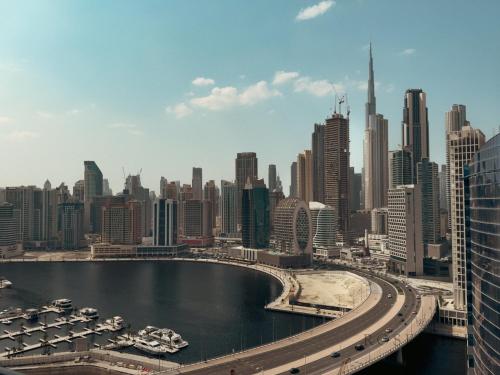 a view of a city with a river and buildings at High Floor The Bay 16 floor by Khalifa & Canal Views in Dubai
