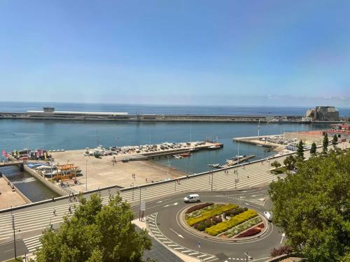 a road in a harbor with a marina with boats at Center Marina view Silver Studio in Funchal