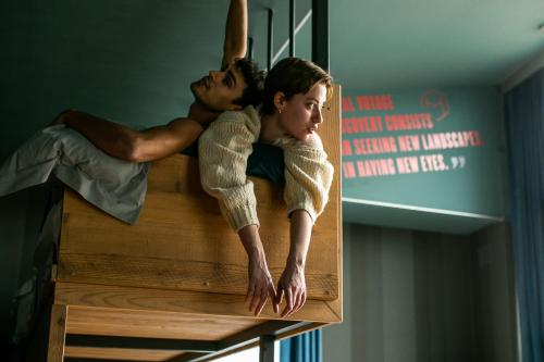 a man and a woman laying on top of a bed at The Modernist Hotel in Trieste