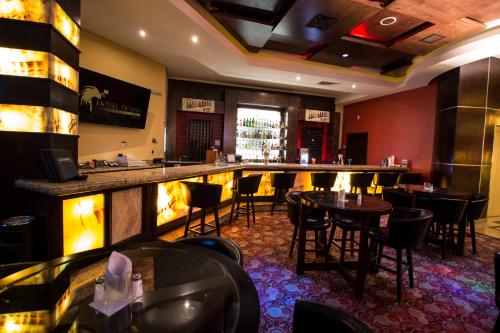 a bar in a restaurant with tables and chairs at Hotel Ticuán in Tijuana