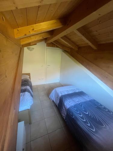 a bedroom with a bed and a wooden ceiling at Casa da Matti in Gravedona