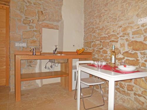 a bathroom with a sink and a table with a mirror at Stone House Apartments in Brtonigla