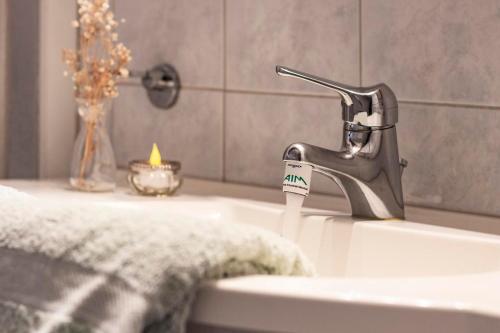 a bathroom sink with a toothbrush and a tooth paste at Il Rustico in Castel San Pietro