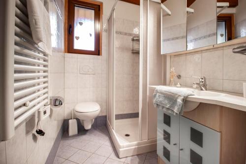 a bathroom with a toilet and a sink and a shower at Il Rustico in Castel San Pietro