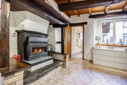 a living room with a fireplace and a bath tub at Il Rustico in Castel San Pietro