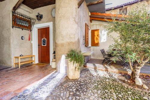 a porch of a house with a wooden door at Il Rustico in Castel San Pietro
