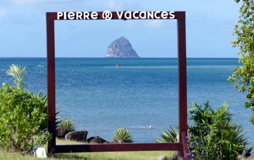 a picture of the ocean with a sign that reads private volcanos at PIERRE & VACANCES Tobago 24 in Sainte-Luce