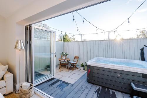 a room with a hot tub on a patio at Leaholme Lodge in Chester