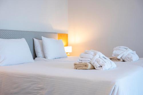 Athina Palace Resort & Spaにあるベッド