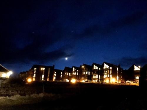 a row of houses at night with the moon in the sky at Heimasta Horn in Tórshavn