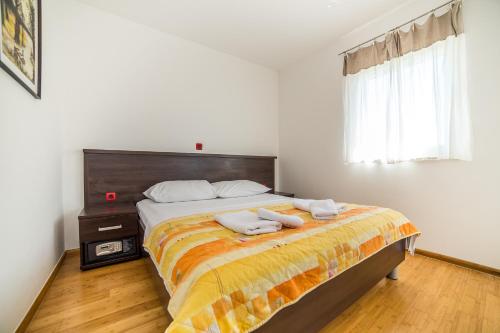 a bedroom with a bed with two towels on it at Villa Tucepi Beach in Tučepi