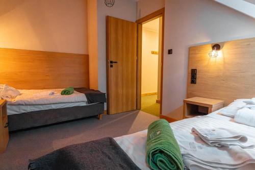 Postel nebo postele na pokoji v ubytování Granada Pensjonat & SPA