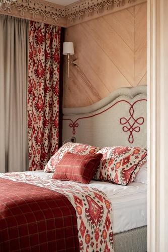 a bedroom with a bed with red and white pillows at Willa na Kozińcu in Zakopane