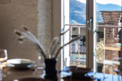 a table with a vase on a table with a window at Il Rustico in Castel San Pietro