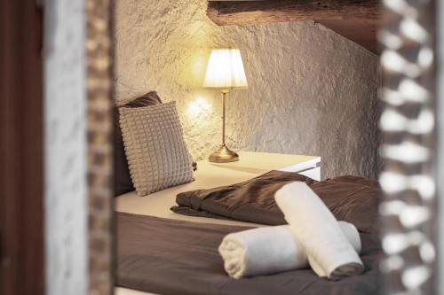 a bedroom with a bed with a lamp on it at Il Rustico in Castel San Pietro