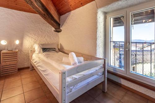 a bedroom with a bed and a large window at Il Rustico in Castel San Pietro