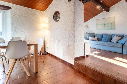 a living room with a blue couch and a table at Il Rustico in Castel San Pietro