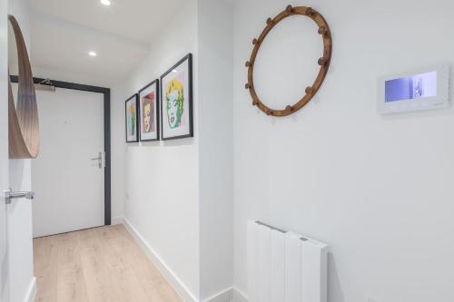 a hallway with white walls and a mirror on the wall at Stunning Central Apt - Balcony & Parking in Cambridge