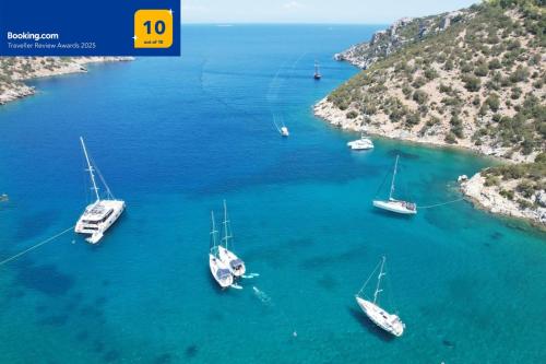 a group of boats in a large body of water at Private Beach House Irene Mare in Poros