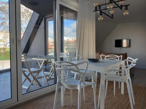 a dining room with a white table and chairs at CITY STAYS BELÉM APARTMENTS in Lisbon
