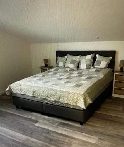 a bedroom with a large bed with pillows on it at FEWO Backbord Huus & Meer in Fehmarn