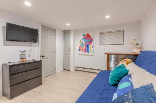 a living room with a blue bed and a flat screen tv at DC colorful place plus Free Parking in Washington