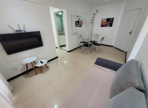 a living room with a couch and a flat screen tv at Spazio Bella Vita · Bela vista em Águas Claras in Brasilia