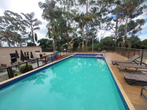 a large swimming pool with a deck with lounge chairs at Spazio Bella Vita · Bela vista em Águas Claras in Brasilia