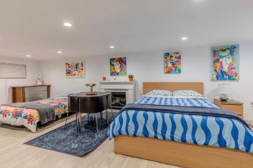 a bedroom with two beds and a desk and a fireplace at DC colorful place plus Free Parking in Washington