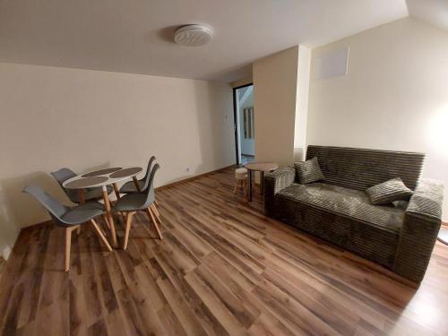 a living room with a couch and a table and chairs at Tygiel Krzywa, Beskid Niski in Krzywa
