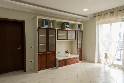 a room with a wooden cabinet and a window at Casa Vacanze Residenziale in Naples