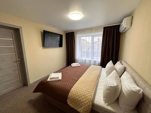 a hotel room with a bed and a window at Yavir in Poltava