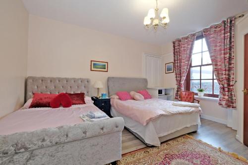 a bedroom with two beds and a couch and a window at Grand Mansion 9 Beds Sleeps 17 Parking - Groups in Aberdeen
