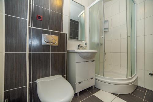 a bathroom with a toilet and a sink and a shower at Villa Tucepi Beach in Tučepi