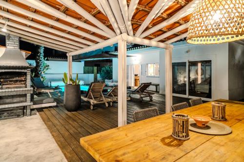 a living room with a wooden table and a dining room at Villa in Comporta Village with heated pool in Comporta