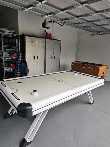 a ping pong table in a room with lockers at Beautiful Clearwater home! in Clearwater