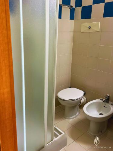 a bathroom with a toilet and a sink at Verdemilia Hotel in Anzola dell'Emilia