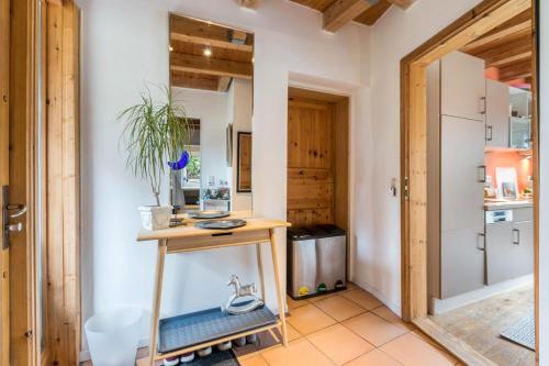 a kitchen with a wooden table and a door at Gästehaus zwischen Meer und Wald in Schiedenhohlweg