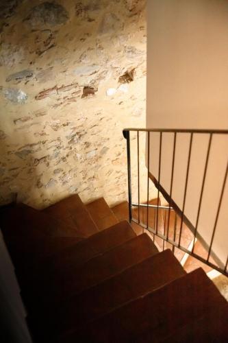 a staircase in a building with a stone wall at Il Mulino di Nonna Sà - Prestige Private Villa in Pietrasanta