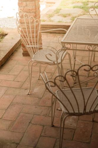 a table and two chairs and a table and a table and chairs at Il Mulino di Nonna Sà - Prestige Private Villa in Pietrasanta