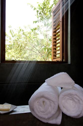 two towels sitting on a table in front of a window at Villas Sur Mer in Negril