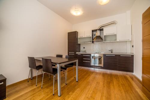 a kitchen with a dining room table and chairs at Villa Tucepi Beach in Tučepi