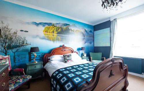 a bedroom with a bed with a painting on the wall at The Mount B&B in Keswick