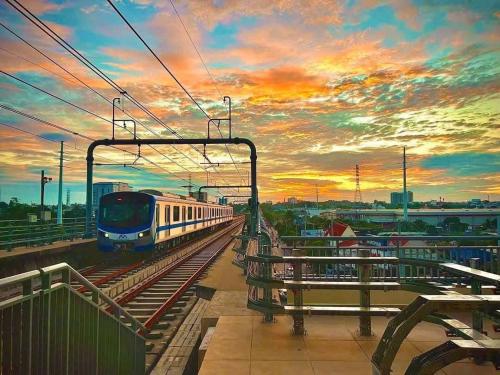 a train on the tracks at a train station at Suzon-Luxurious Apartment at Lumiere Boulevard VGP in Gò Công
