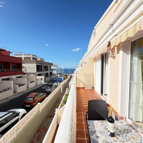 a balcony with a table and chairs on a building at Apartamento Wanda junto al MAR in Puerto Naos