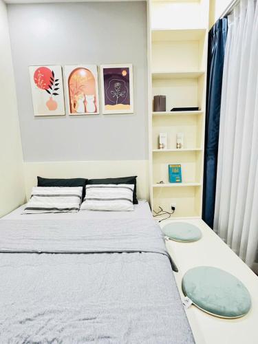 a small bedroom with a bed and a book shelf at Suzon-Luxurious Apartment at Lumiere Boulevard VGP in Gò Công