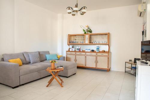 a living room with a couch and a table at Under the Lemon Tree in La Caletta