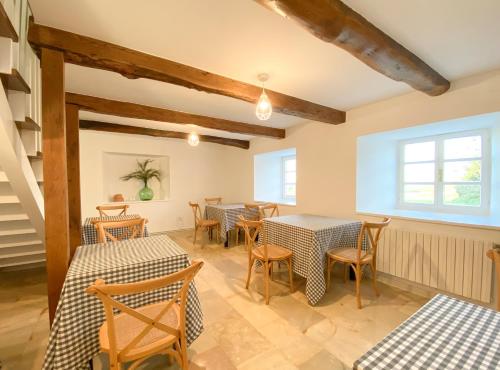 a restaurant with tables and chairs in a room at Casa Pastur in Serantes