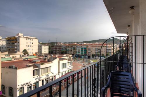 a balcony with a view of a city with buildings at El Cid in Sitges