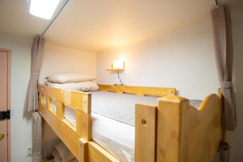 two bunk beds in a small room at YAB-GuestHouse, FemaleOnly, ForeignOnly in Seoul